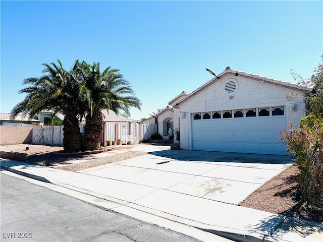 1860 Banaba Ln, Las Vegas, NV 89156 - view of front of home featuring a garage, concrete driveway, and stucco siding