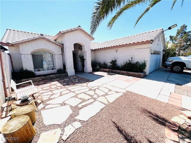 1860 Banaba Ln, Las Vegas, NV 89156 - mediterranean / spanish-style house with a tile roof, stucco siding, and concrete driveway