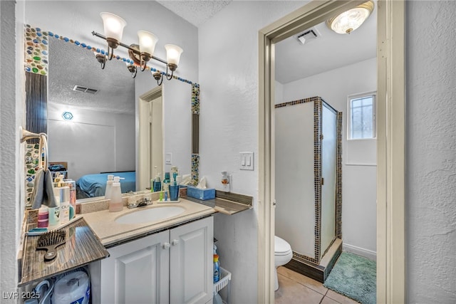 54 Del Amo Dr, Las Vegas, NV 89110 - bathroom featuring toilet, a textured ceiling, a shower stall, tile patterned floors, and vanity