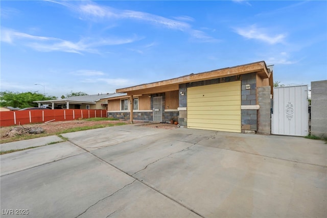 54 Del Amo Dr, Las Vegas, NV 89110 - single story home featuring stone siding, a garage, and driveway
