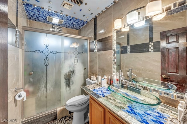 54 Del Amo Dr, Las Vegas, NV 89110 - full bath with tile walls, toilet, a stall shower, and vanity