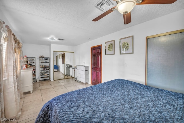 54 Del Amo Dr, Las Vegas, NV 89110 - tiled bedroom featuring a textured ceiling and a ceiling fan