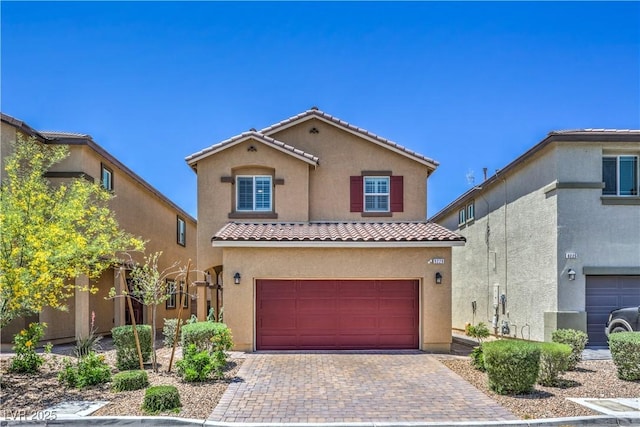 9229 Brayden Bay St, Las Vegas, NV 89178 - mediterranean / spanish-style home featuring a tile roof, stucco siding, a garage, and decorative driveway