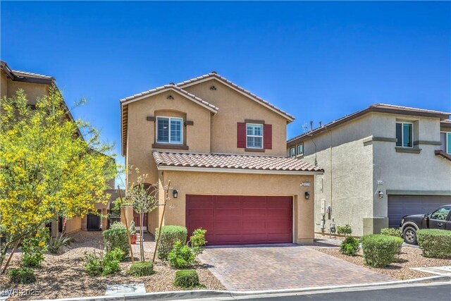 9229 Brayden Bay St, Las Vegas, NV 89178 - mediterranean / spanish house featuring a tile roof, stucco siding, an attached garage, and driveway