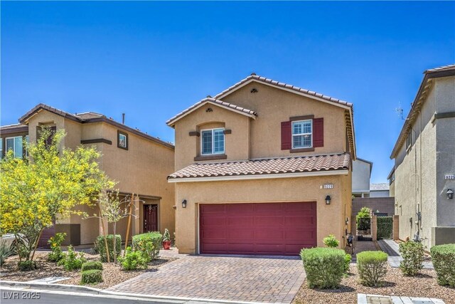 9229 Brayden Bay St, Las Vegas, NV 89178 - mediterranean / spanish-style house featuring a tile roof, stucco siding, a garage, and decorative driveway