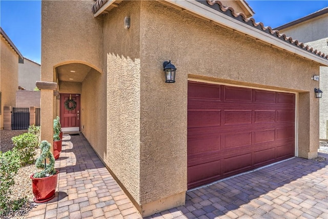 9229 Brayden Bay St, Las Vegas, NV 89178 - property entrance featuring stucco siding, a tile roof, and a garage