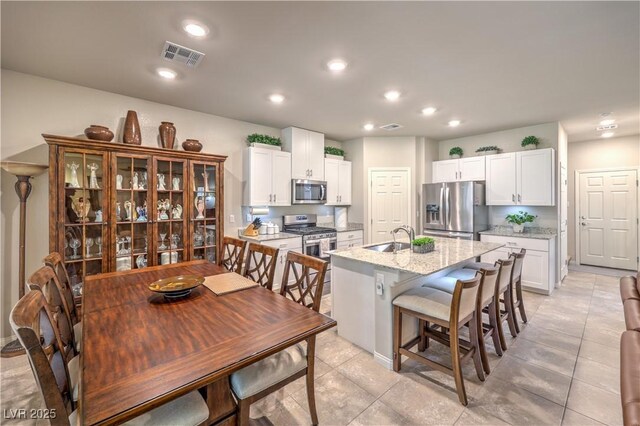 9229 Brayden Bay St, Las Vegas, NV 89178 - dining space with recessed lighting and light tile patterned flooring