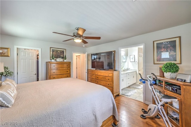 9229 Brayden Bay St, Las Vegas, NV 89178 - bedroom with light wood finished floors, ensuite bathroom, and ceiling fan