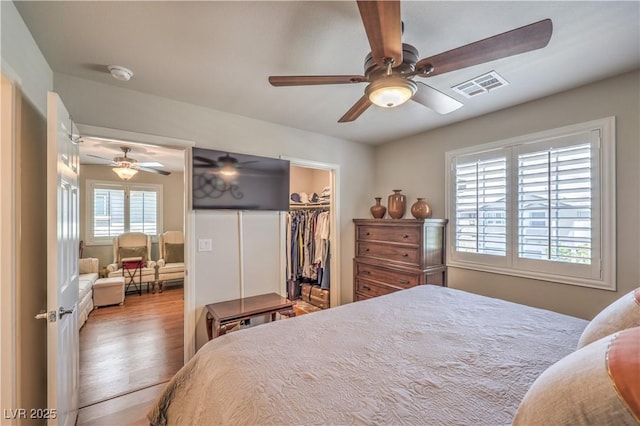 9229 Brayden Bay St, Las Vegas, NV 89178 - bedroom featuring wood finished floors, a spacious closet, ceiling fan, and a closet