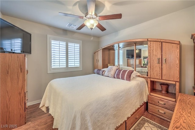 9229 Brayden Bay St, Las Vegas, NV 89178 - bedroom with baseboards, wood finished floors, and a ceiling fan