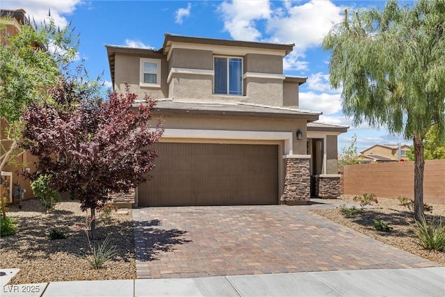 6783 Pleasant Flower St, Las Vegas, NV 89149 - view of front of house with stucco siding, a garage, decorative driveway, and stone siding