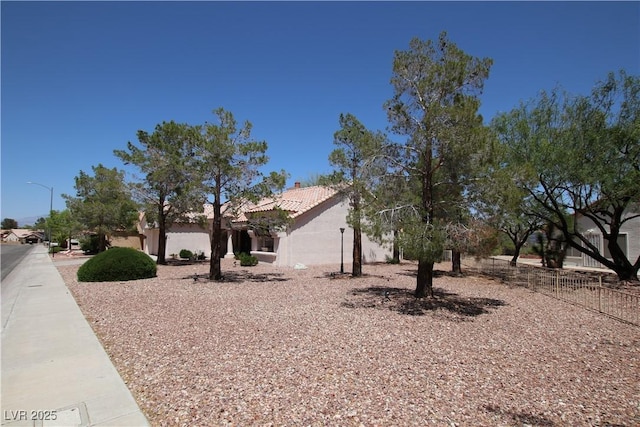 2820 Bluff Point Dr, Las Vegas, NV 89134 - view of side of property featuring stucco siding, a tiled roof, and a chimney