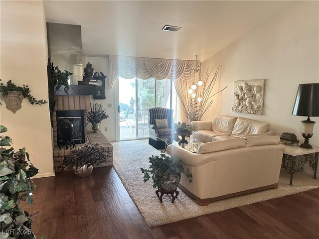 2820 Bluff Point Dr, Las Vegas, NV 89134 - living area with wood finished floors, a glass covered fireplace, and baseboards