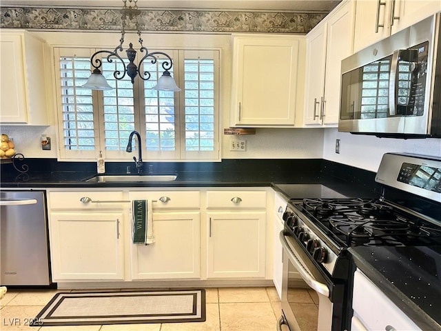 2820 Bluff Point Dr, Las Vegas, NV 89134 - kitchen with stainless steel appliances, a sink, dark countertops, light tile patterned flooring, and white cabinetry