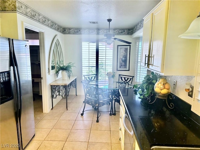 2820 Bluff Point Dr, Las Vegas, NV 89134 - kitchen featuring appliances with stainless steel finishes, light tile patterned flooring, ceiling fan, and a textured ceiling