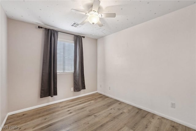 9053 Entrancing Ave, Las Vegas, NV 89149 - spare room featuring wood finished floors, baseboards, and ceiling fan