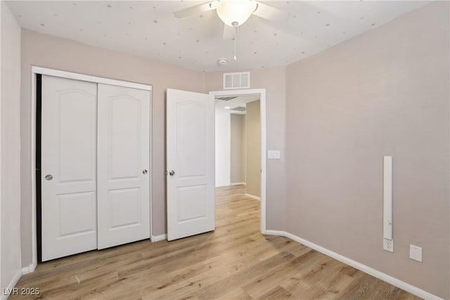 9053 Entrancing Ave, Las Vegas, NV 89149 - unfurnished bedroom featuring light wood-style floors, baseboards, a closet, and a ceiling fan