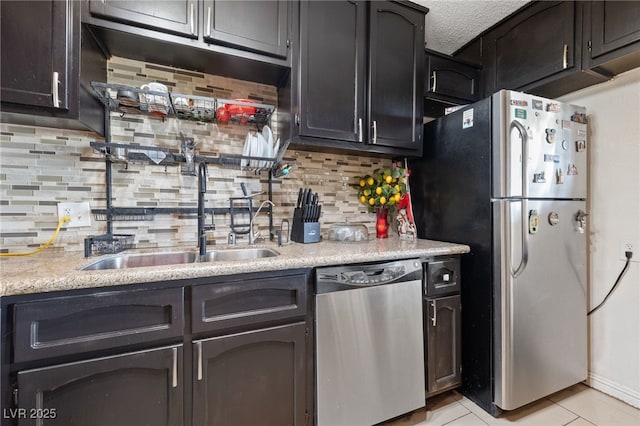 1916 Canosa Ave, Las Vegas, NV 89104 - kitchen featuring appliances with stainless steel finishes, a sink, tasteful backsplash, and light tile patterned floors