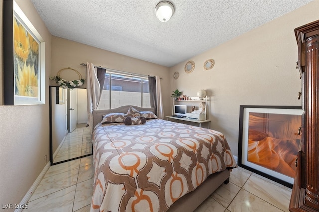 1916 Canosa Ave, Las Vegas, NV 89104 - bedroom with light marble finish floors, a textured ceiling, and baseboards