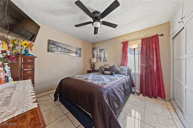 1916 Canosa Ave, Las Vegas, NV 89104 - bedroom featuring a textured ceiling, light marble finish flooring, baseboards, and ceiling fan