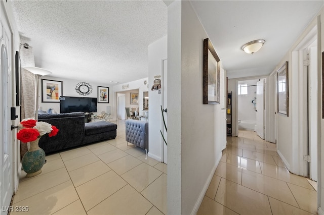 1916 Canosa Ave, Las Vegas, NV 89104 - hall with light tile patterned floors, baseboards, and a textured ceiling