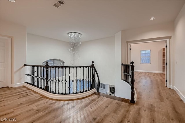 2448 Ram Crossing Way, Henderson, NV 89074 - hallway featuring an upstairs landing, wood finished floors, baseboards, a chandelier, and recessed lighting