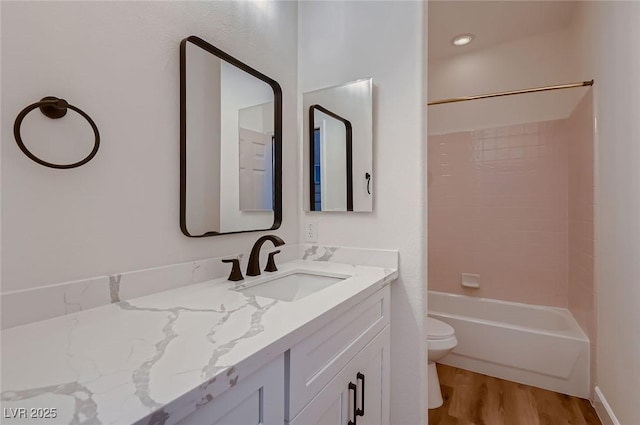2448 Ram Crossing Way, Henderson, NV 89074 - bathroom with toilet, wood finished floors, vanity, and bathing tub / shower combination