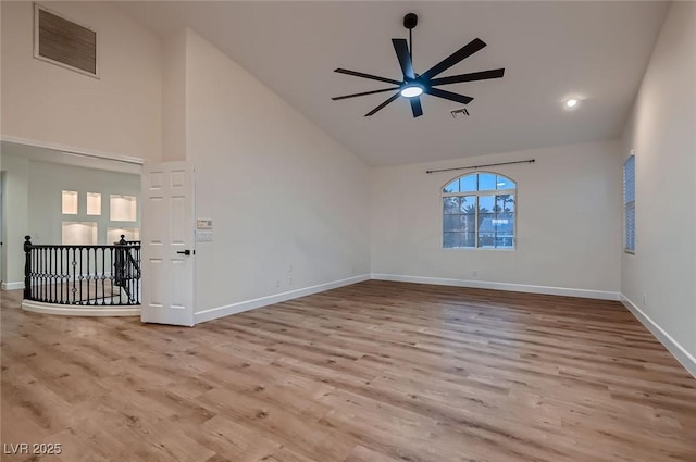 2448 Ram Crossing Way, Henderson, NV 89074 - empty room with high vaulted ceiling, ceiling fan, wood finished floors, baseboards, and recessed lighting