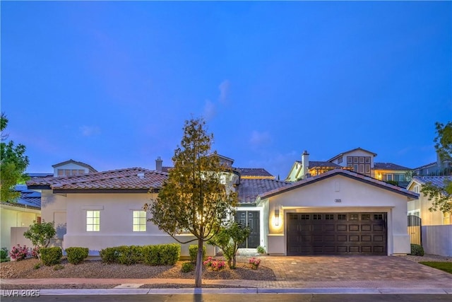 3020 Via Venezia, Henderson, NV 89052 - mediterranean / spanish home featuring a tiled roof, stucco siding, and an attached garage