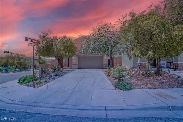 2529 Flodden St, Henderson, NV 89044 - obstructed view of property featuring driveway, stucco siding, and a garage