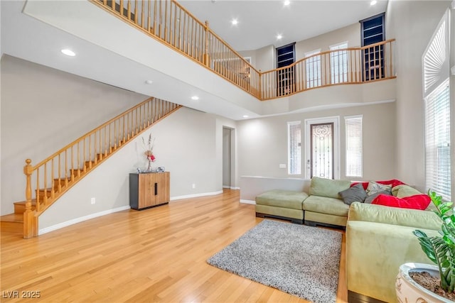2529 Flodden St, Henderson, NV 89044 - living area featuring stairs, wood finished floors, a towering ceiling, baseboards, and recessed lighting