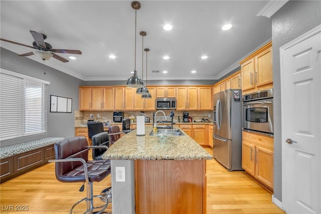 2529 Flodden St, Henderson, NV 89044 - kitchen featuring appliances with stainless steel finishes, tasteful backsplash, a kitchen bar, a ceiling fan, and crown molding