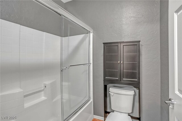 2529 Flodden St, Henderson, NV 89044 - full bath featuring a textured wall, toilet, and combined bath / shower with glass door