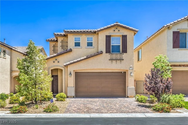12286 Silvana St, Las Vegas, NV 89141 - view of front of house featuring a garage, stucco siding, a tiled roof, and driveway