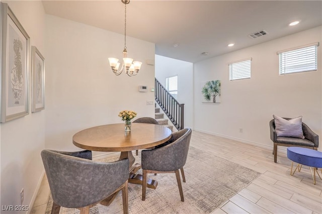 12286 Silvana St, Las Vegas, NV 89141 - dining space featuring a chandelier, light wood-type flooring, stairway, baseboards, and recessed lighting