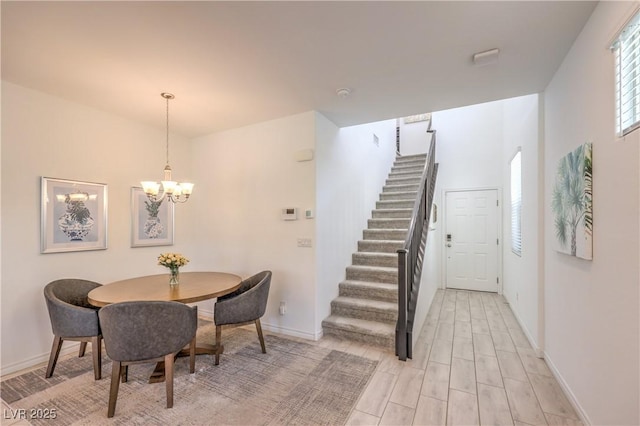 12286 Silvana St, Las Vegas, NV 89141 - dining room with a chandelier, stairs, baseboards, and light wood-style flooring