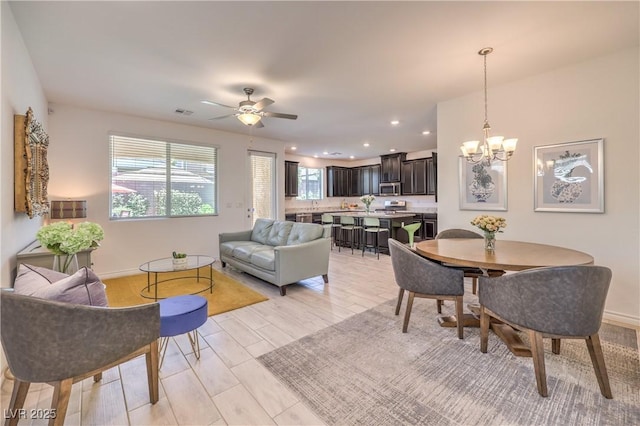 12286 Silvana St, Las Vegas, NV 89141 - dining room featuring a chandelier, recessed lighting, a ceiling fan, baseboards, and light wood-style flooring