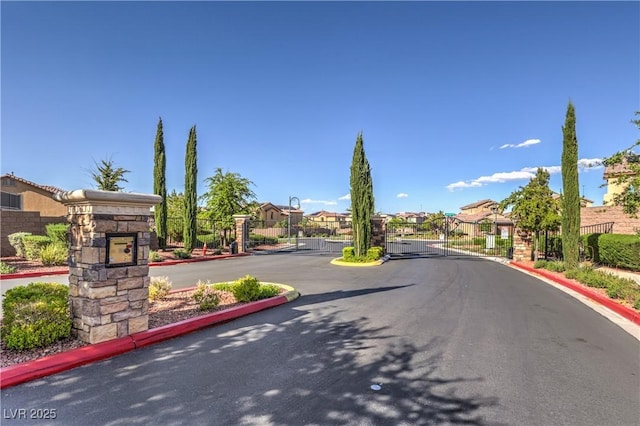 12286 Silvana St, Las Vegas, NV 89141 - view of asphalt road featuring a gate, a gated entry, curbs, and a residential view