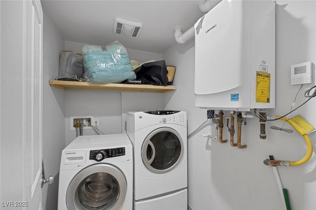 603 Palmhurst Dr, Las Vegas, NV 89145 - laundry area with tankless water heater and washing machine and clothes dryer