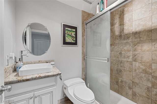 603 Palmhurst Dr, Las Vegas, NV 89145 - bathroom featuring vanity, a shower stall, and toilet