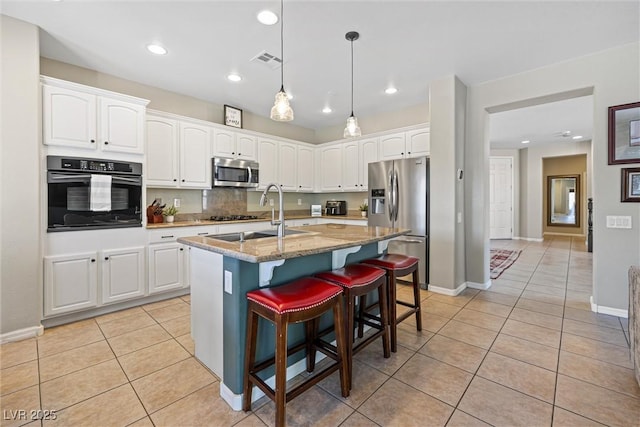 820 Colina Alta Pl, Las Vegas, NV 89138 - kitchen featuring black appliances, a sink, light tile patterned floors, light stone countertops, and white cabinets