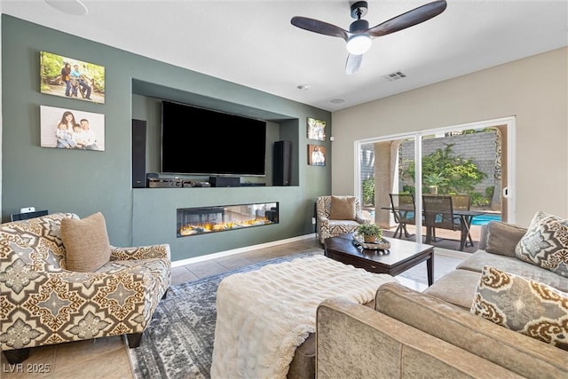 820 Colina Alta Pl, Las Vegas, NV 89138 - living area featuring a ceiling fan, tile patterned floors, a glass covered fireplace, and baseboards