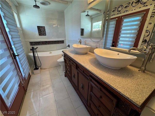 1819 Beverly Way, Las Vegas, NV 89104 - bathroom with double vanity, tile walls, a freestanding tub, a tile shower, and toilet