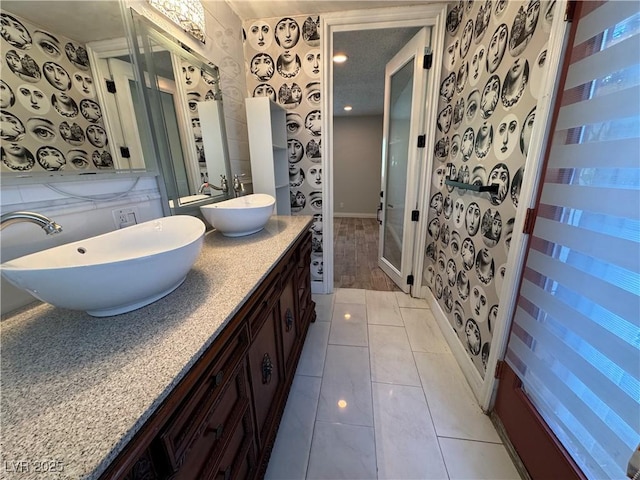 1819 Beverly Way, Las Vegas, NV 89104 - bathroom with wallpapered walls, double vanity, baseboards, and tile patterned floors