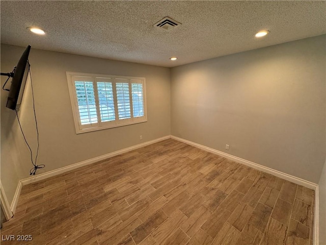 1819 Beverly Way, Las Vegas, NV 89104 - spare room with wood finished floors, recessed lighting, baseboards, and a textured ceiling
