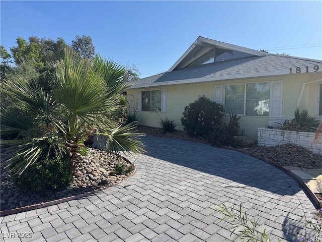 1819 Beverly Way, Las Vegas, NV 89104 - view of home's exterior featuring stucco siding, roof with shingles, and decorative driveway