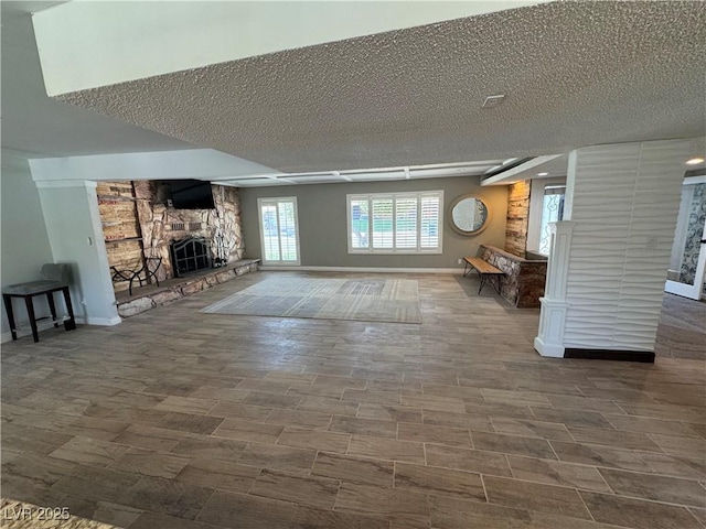 1819 Beverly Way, Las Vegas, NV 89104 - living area featuring a stone fireplace, a textured ceiling, and baseboards