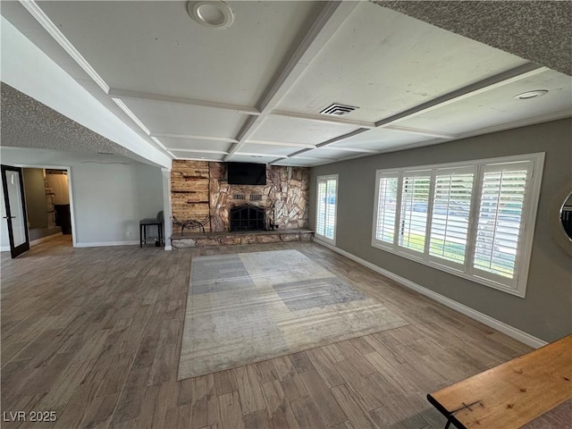 1819 Beverly Way, Las Vegas, NV 89104 - unfurnished living room with baseboards, wood finished floors, a stone fireplace, coffered ceiling, and beam ceiling