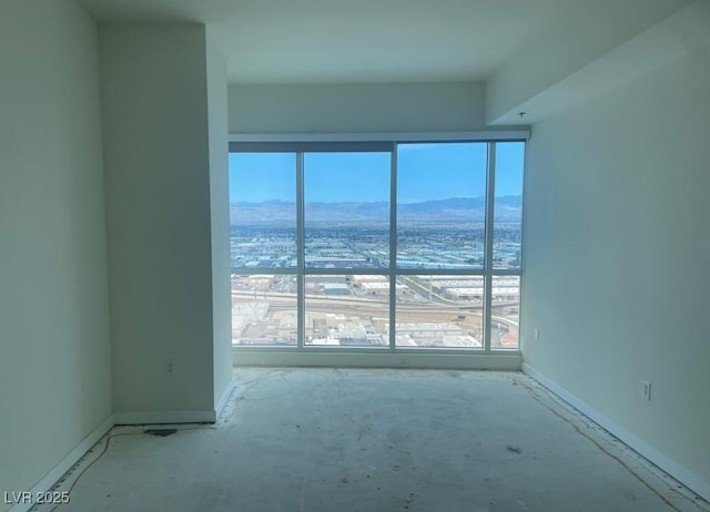 4575 Dean Martin Dr Unit 3206, Las Vegas, NV 89103 - spare room featuring a mountain view, healthy amount of natural light, and baseboards