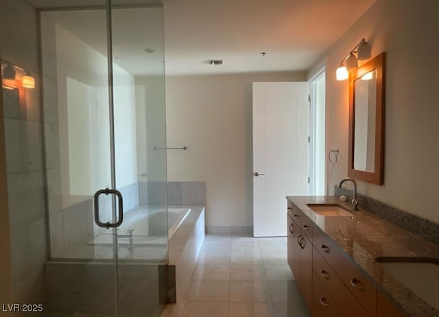 4575 Dean Martin Dr Unit 3206, Las Vegas, NV 89103 - full bathroom featuring a garden tub, double vanity, a shower stall, and tile patterned flooring